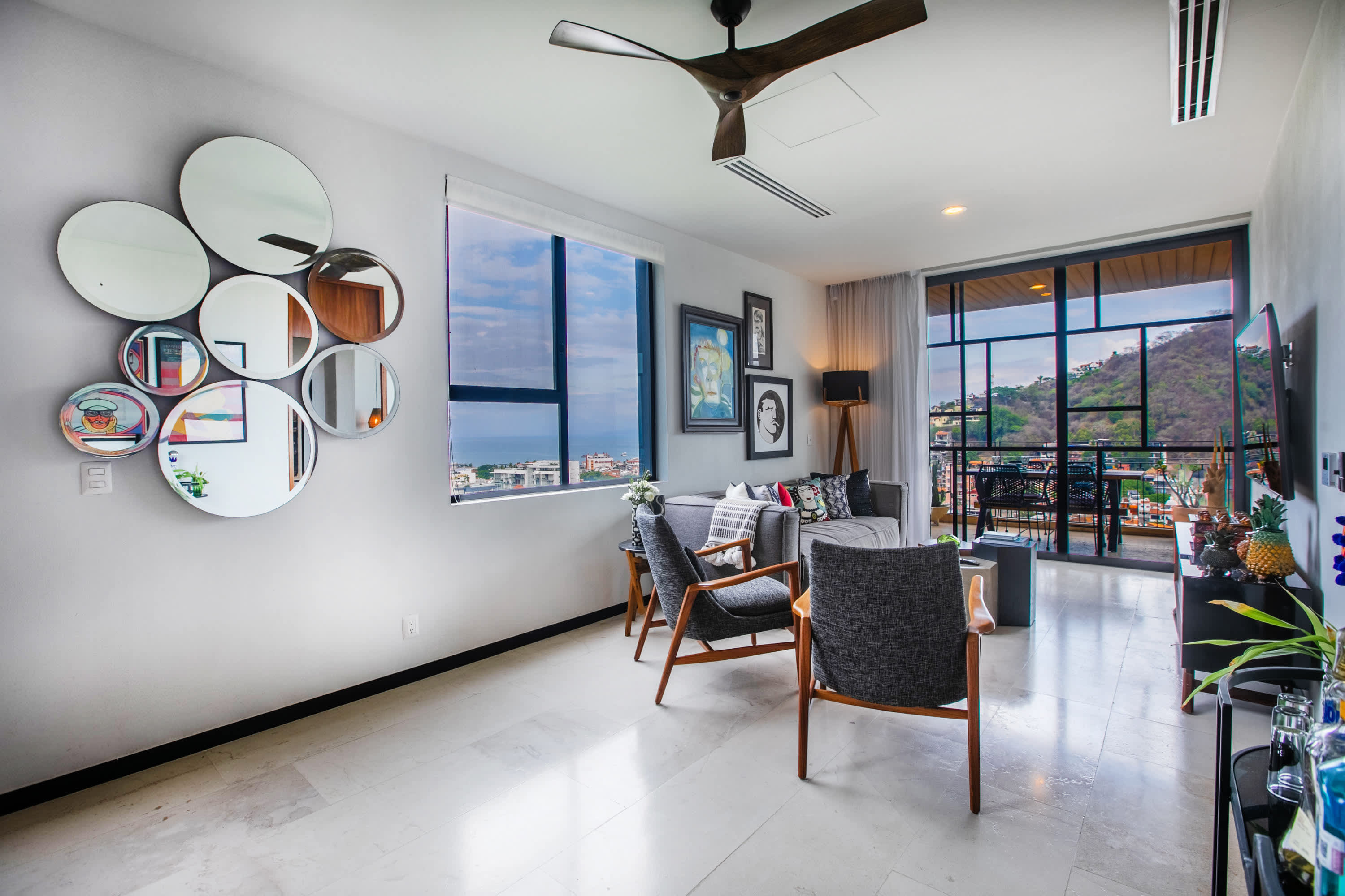 Living room with gallery wall and balcony view